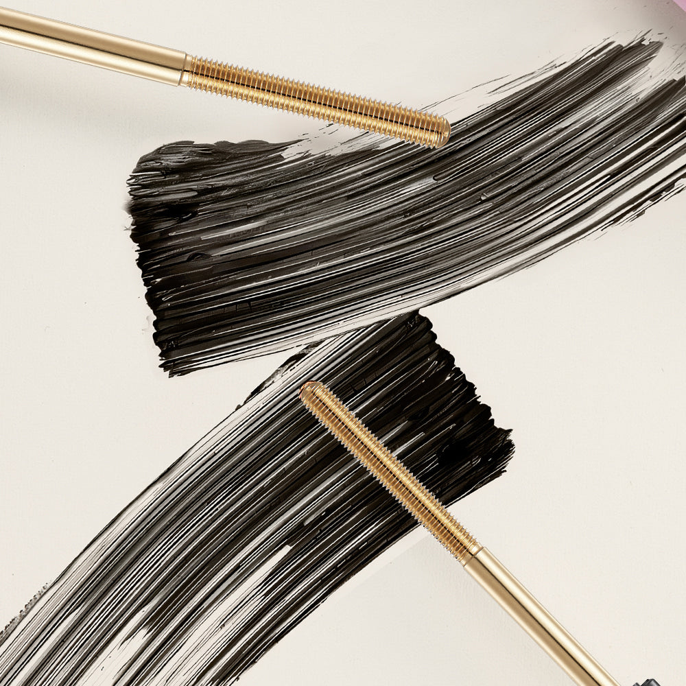 NEOGEN Volumizing Metal Mascara 4ml with brush strokes on a surface