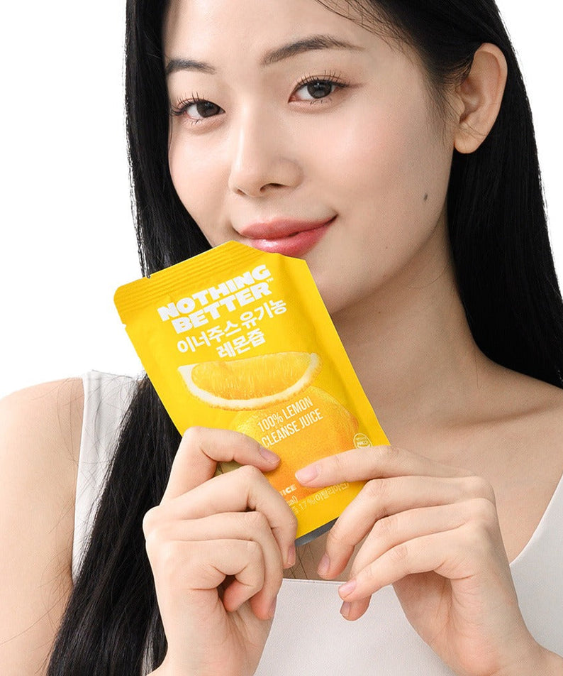 Woman holding NOTHING BETTER Inner Juice 100% Lemon Cleanse Juice 100ml (X24) pack.