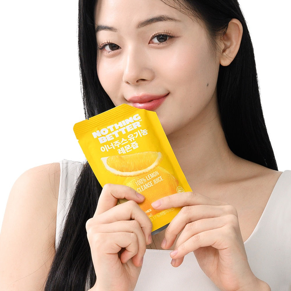 Woman holding NOTHING BETTER Inner Juice 100% Lemon Cleanse Juice 100ml (X24) pack.