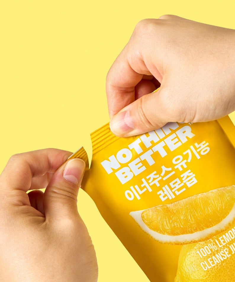 Woman opening a packet of NOTHING BETTER Inner Juice 100% Lemon Cleanse Juice 100ml (X24), showcasing vibrant lemon graphics on yellow packaging.