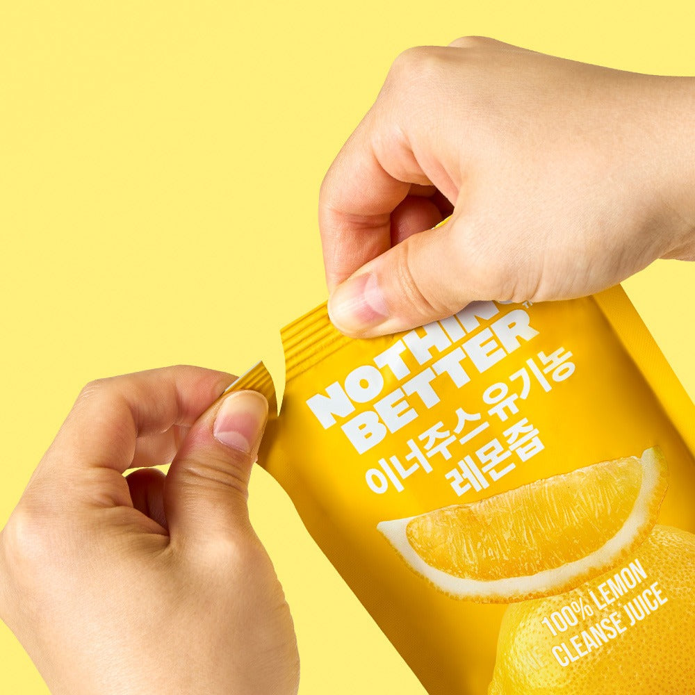 Woman opening a packet of NOTHING BETTER Inner Juice 100% Lemon Cleanse Juice 100ml (X24), showcasing vibrant lemon graphics on yellow packaging.