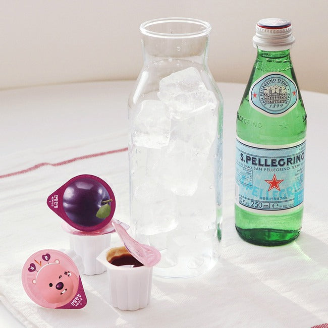 NOTHING BETTER Zanmang Loopy Cup Purun & Lactobacillus 14p with ice-filled glass and sparkling water bottle on a table.