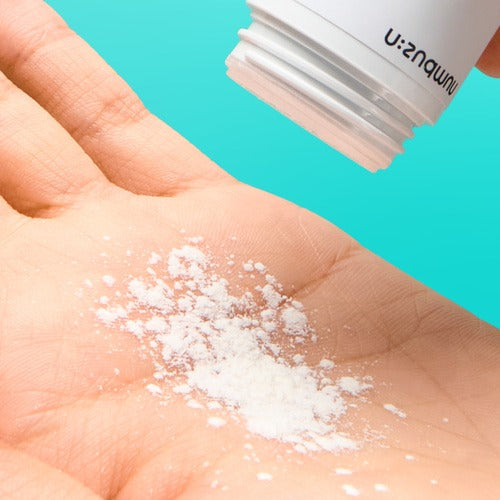 NUMBUZIN No.1 Pantothenic Acid Active Up Dressing Powder 7g being dispensed into hand against a turquoise background.