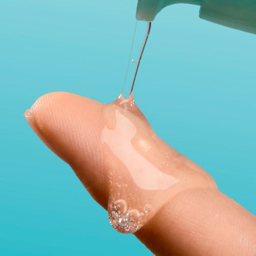 NUMBUZIN No.1 Pantothenic Acid Active Up Soothing Serum 50ml being dispensed onto a finger against a blue background.