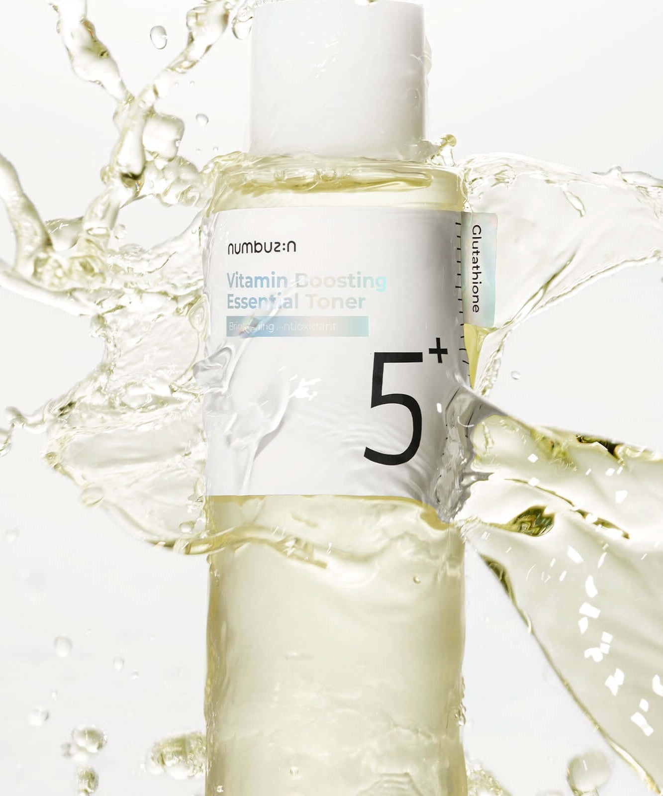 NUMBUZIN No.5 Vitamin Boosting Essential Toner bottle with splashing liquid background