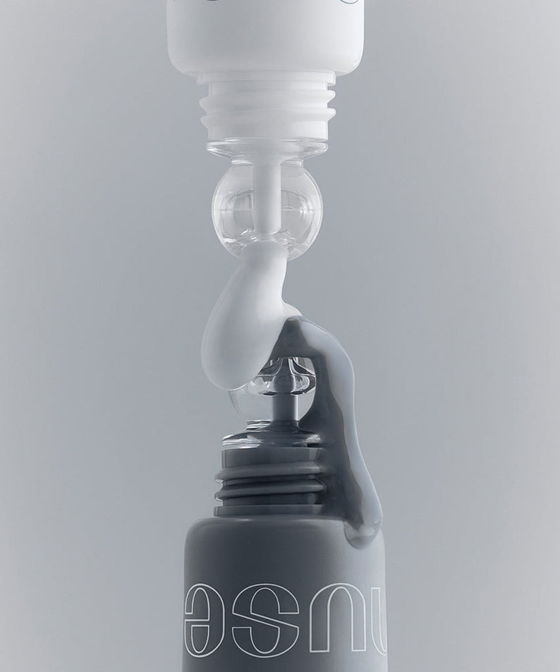NUSE Mousse Care Cheek Handy being dispensed from a bottle against a neutral background, highlighting its texture and design.