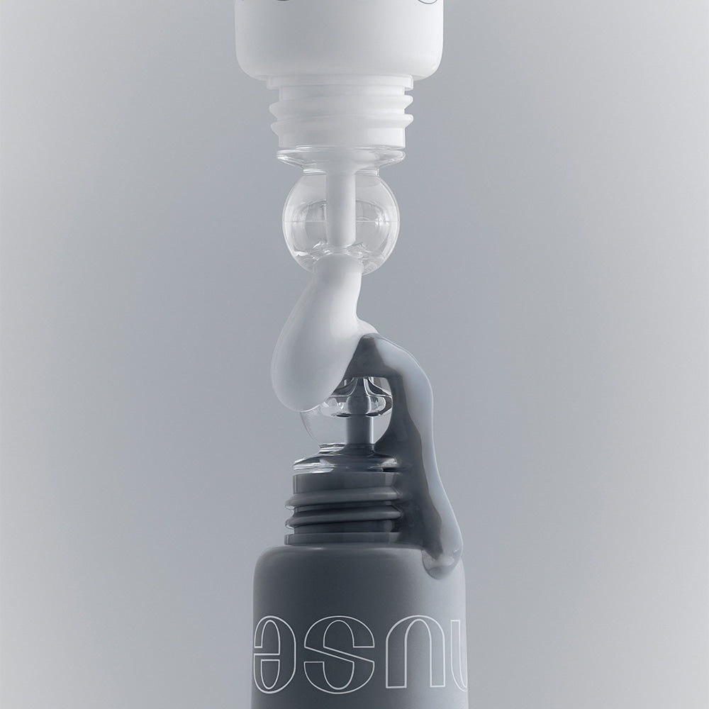 NUSE Mousse Care Cheek Handy being dispensed from a bottle against a neutral background, highlighting its texture and design.