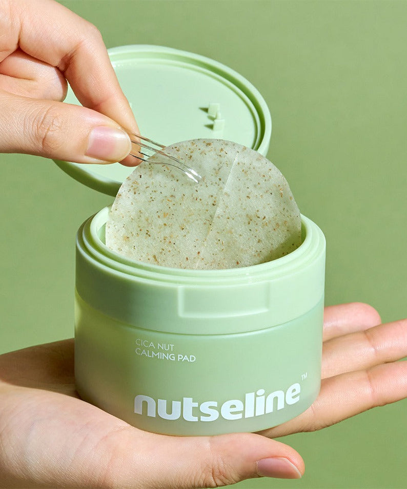 Person holding a NUTSELINE Cica Calming Pad container with open lid and visible calming pad inside.