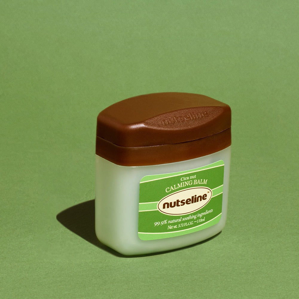 NUTSELINE Cica Nut Calming Balm Season 2 50ml jar on green background