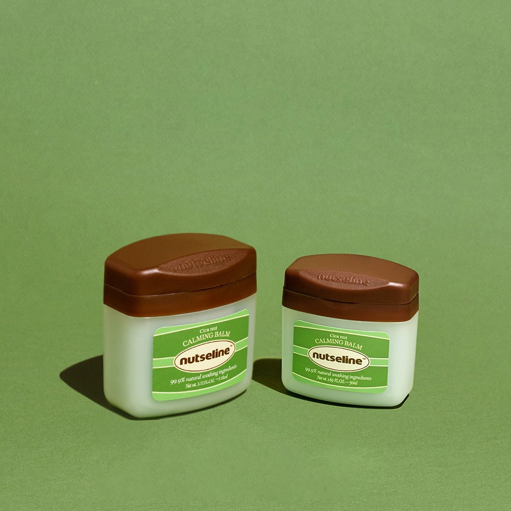 Two jars of NUTSELINE Cica Nut Calming Balm Season 2 50ml on a green background.