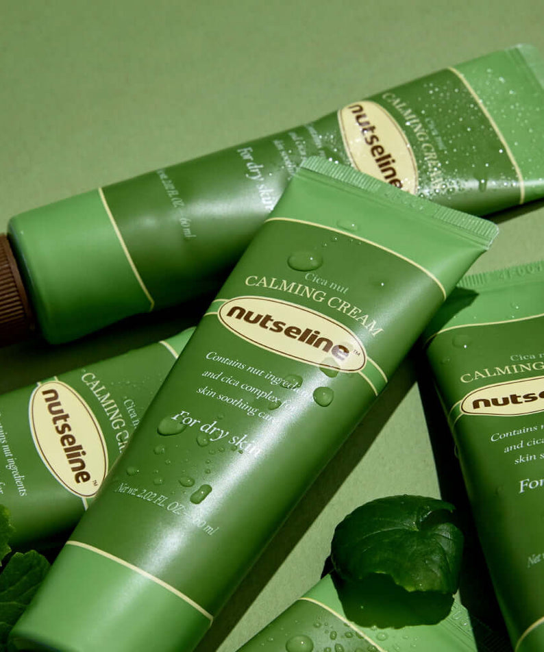 NUTSELINE Cica Nut Calming Cream 60ml tubes displayed on green background, highlighting skincare product for dry skin.