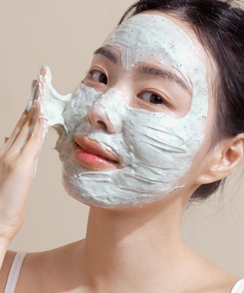 Woman applying NUTSELINE Mint Chocolate Cleansing Pack Foam 130g on face