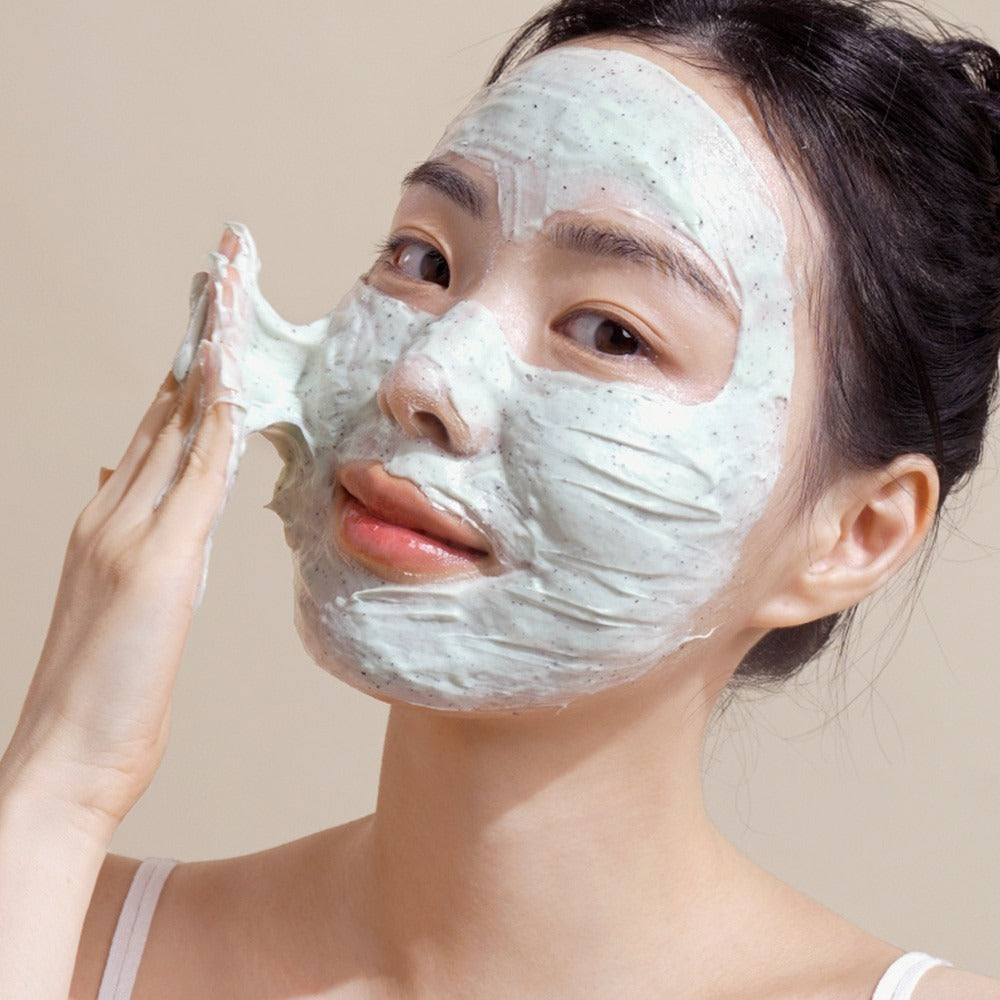Woman applying NUTSELINE Mint Chocolate Cleansing Pack Foam 130g on face