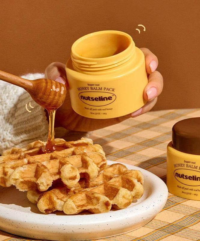 NUTSELINE Super Nut Honey Balm Pack 100g next to waffles and honey dipper.