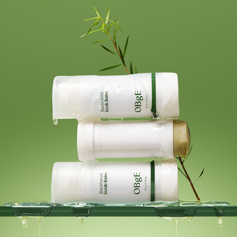 OBGE Blackhead Scrub Balm 20g - Gentleman Korea product shot showing three white scrub balm sticks with green accents on a fresh green background, Korean men's skincare