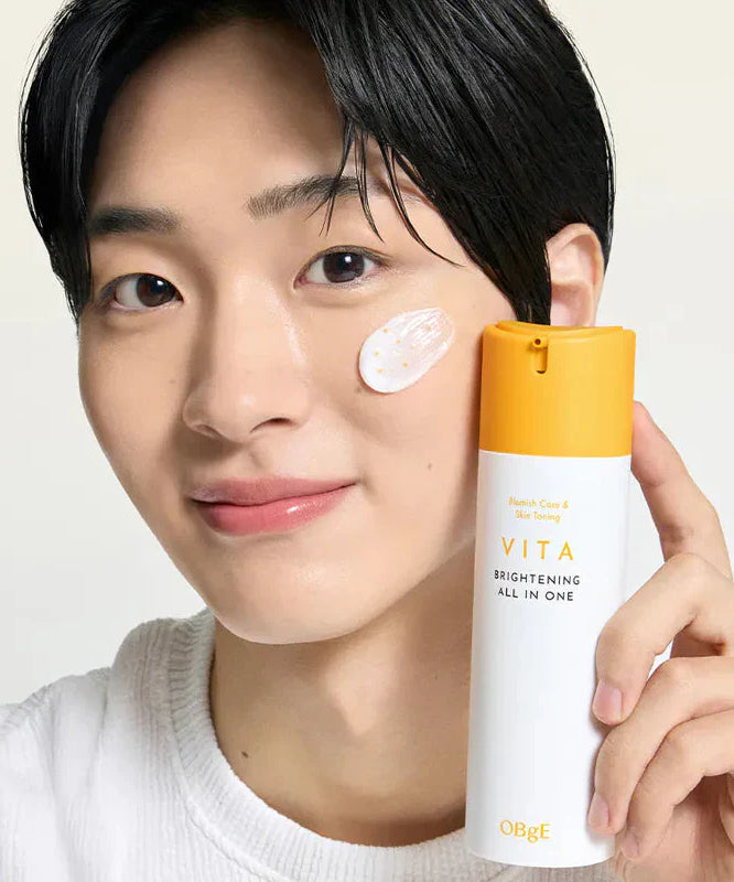 OBGE Vita Brightening All-in-One 150ml bottle held by smiling man applying cream on cheek, Gentleman Korea product shot