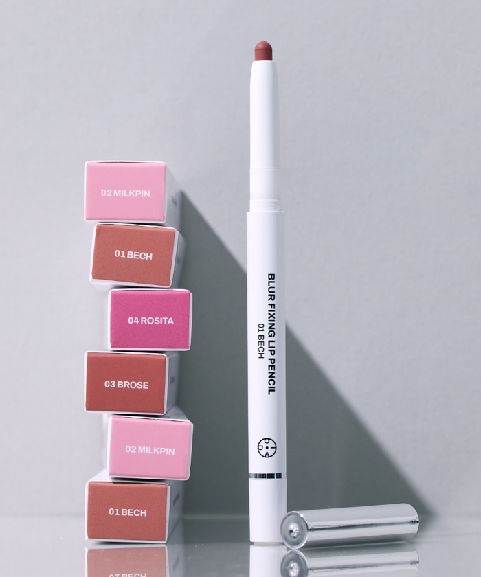 OIAD Blur Fixing Lip Pencil next to various lipstick shades in a sleek design