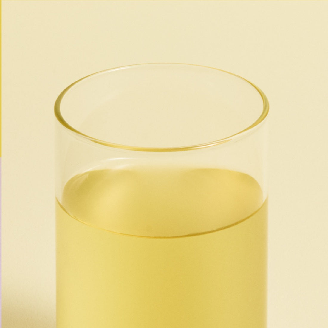 Glass of OSULLOC Canola & Apricot Tea 20 P on a neutral background