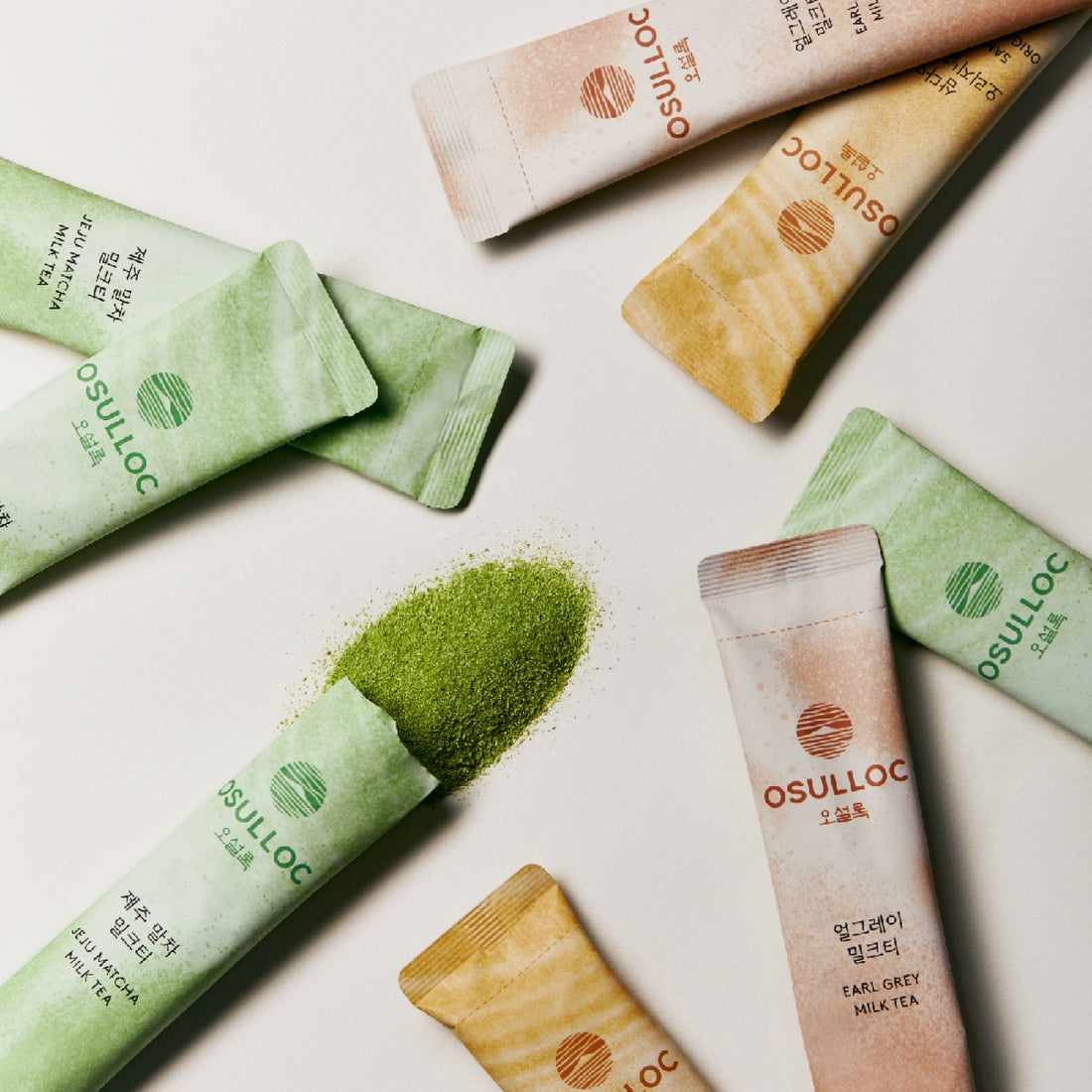 OSULLOC Earl Grey Milk Tea 10 p sachets displayed with matcha tea powder spill