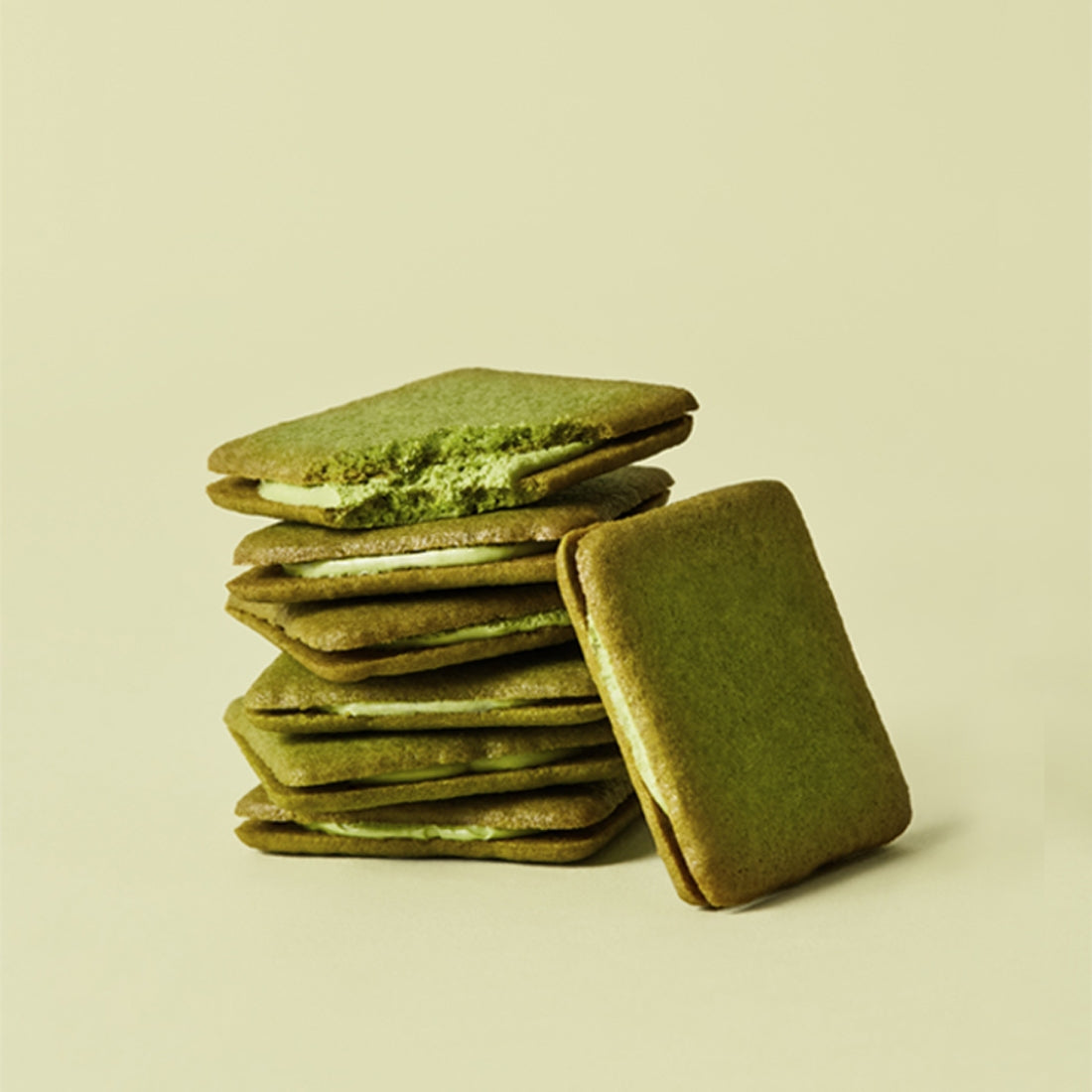 Stack of OSULLOC Green Tea Langue de chat 10 p biscuits with matcha filling on a light background.