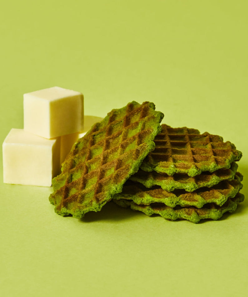 OSULLOC Premium Green Tea Waffle 72g with butter cubes on a green background.