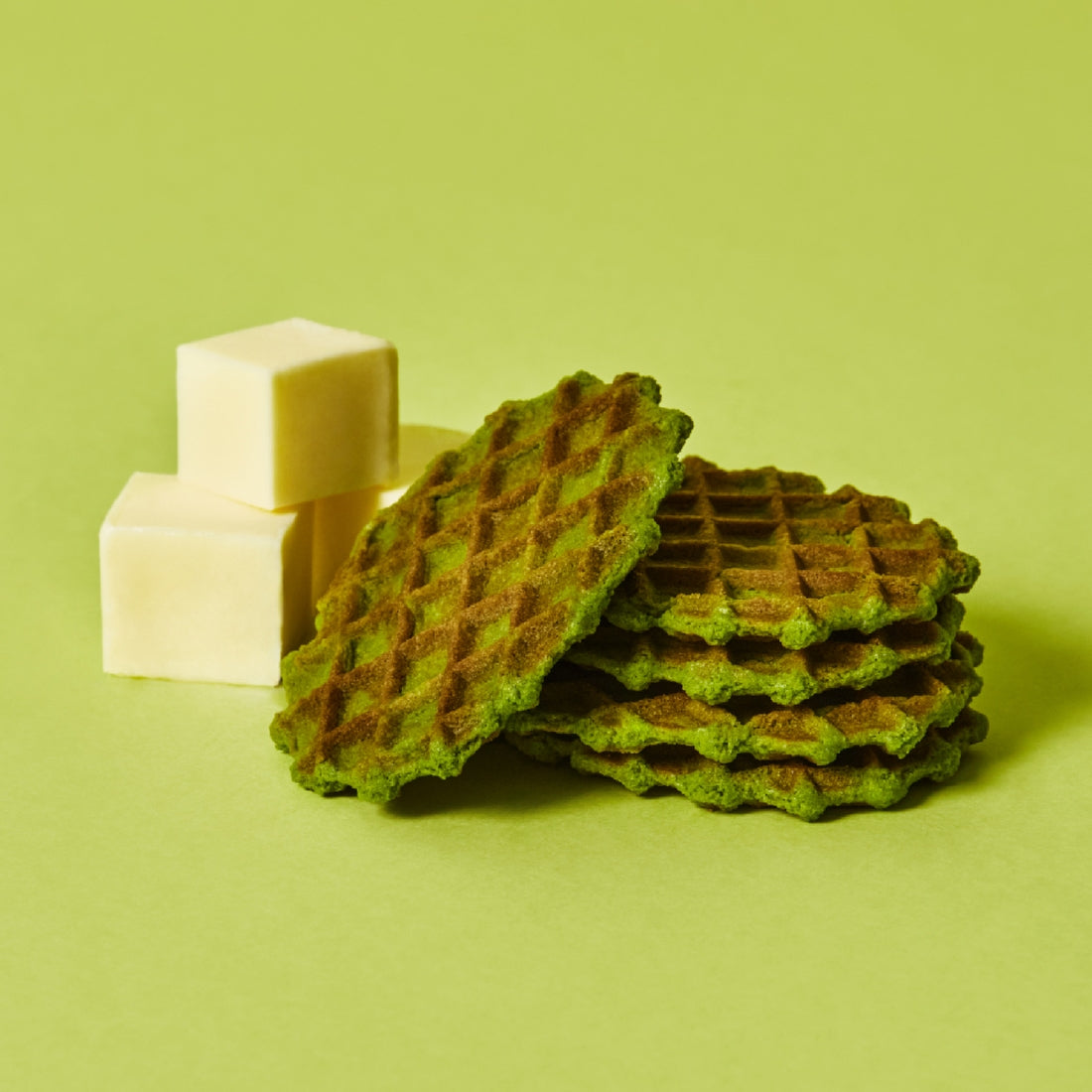 OSULLOC Premium Green Tea Waffle 72g with butter cubes on a green background.