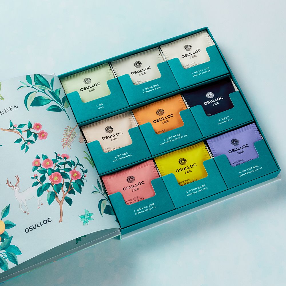 Assorted tea collection in OSULLOC Tea Garden Set 2025, featuring colorful packaging inside an open gift box.