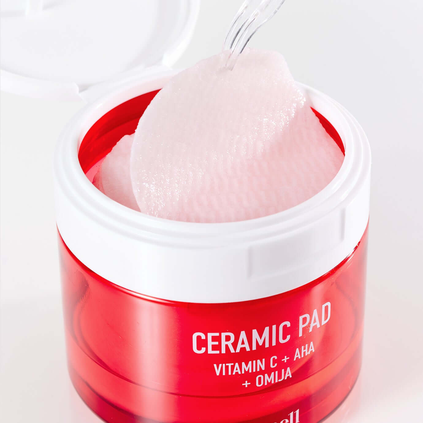 PARNELL AHA Omija Ceramic Pad 60 Pads showing pink textured skincare pads in an open red container with spatula