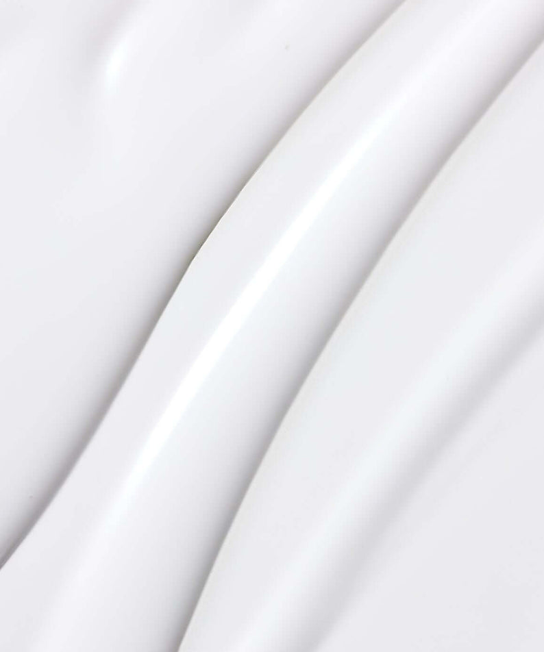 Texture of PARNELL Niacinamide 4.12 Rice Brightening Ampoule Toner 200ml on a smooth surface