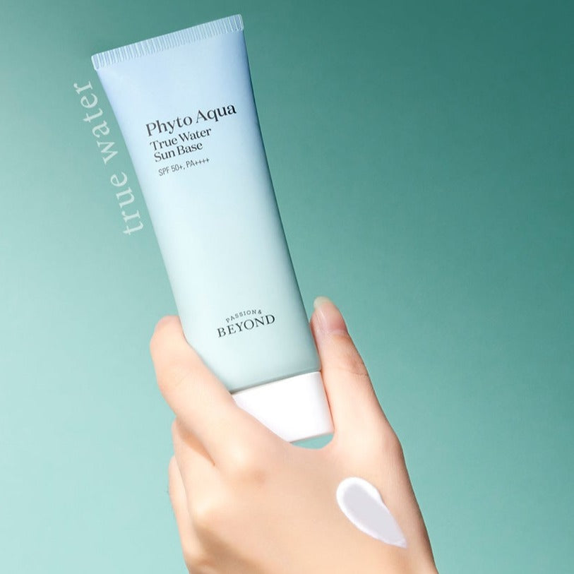 PASSION & BEYOND Phyto Aqua True Water Sun Base SPF50+ held by a hand with cream texture visible