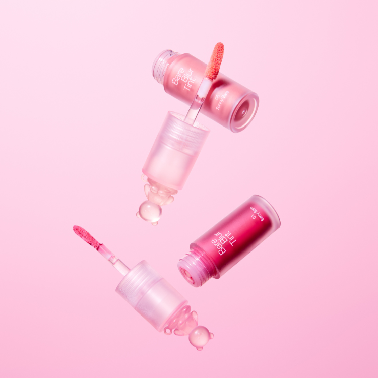 PASSION CAT Bere Blur Tint in pink bottles on a matching background. Beauty and makeup product image showcasing vibrant tint colors.
