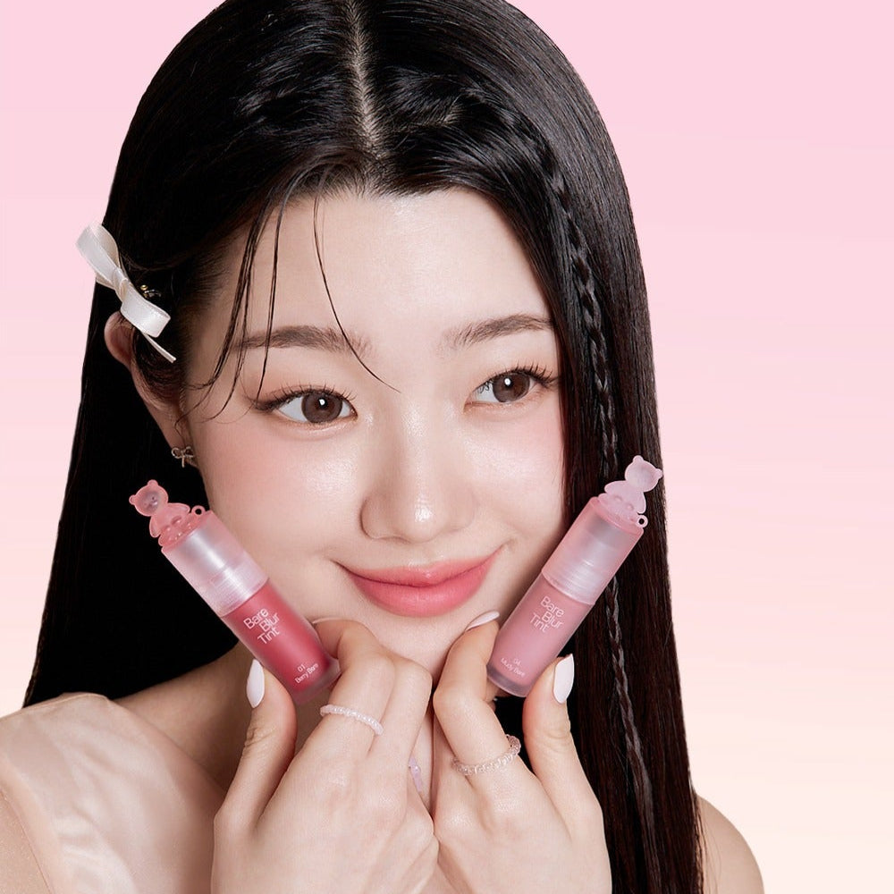 Young woman holding PASSION CAT Bere Blur Tint against a pink background, showcasing vibrant lip color options