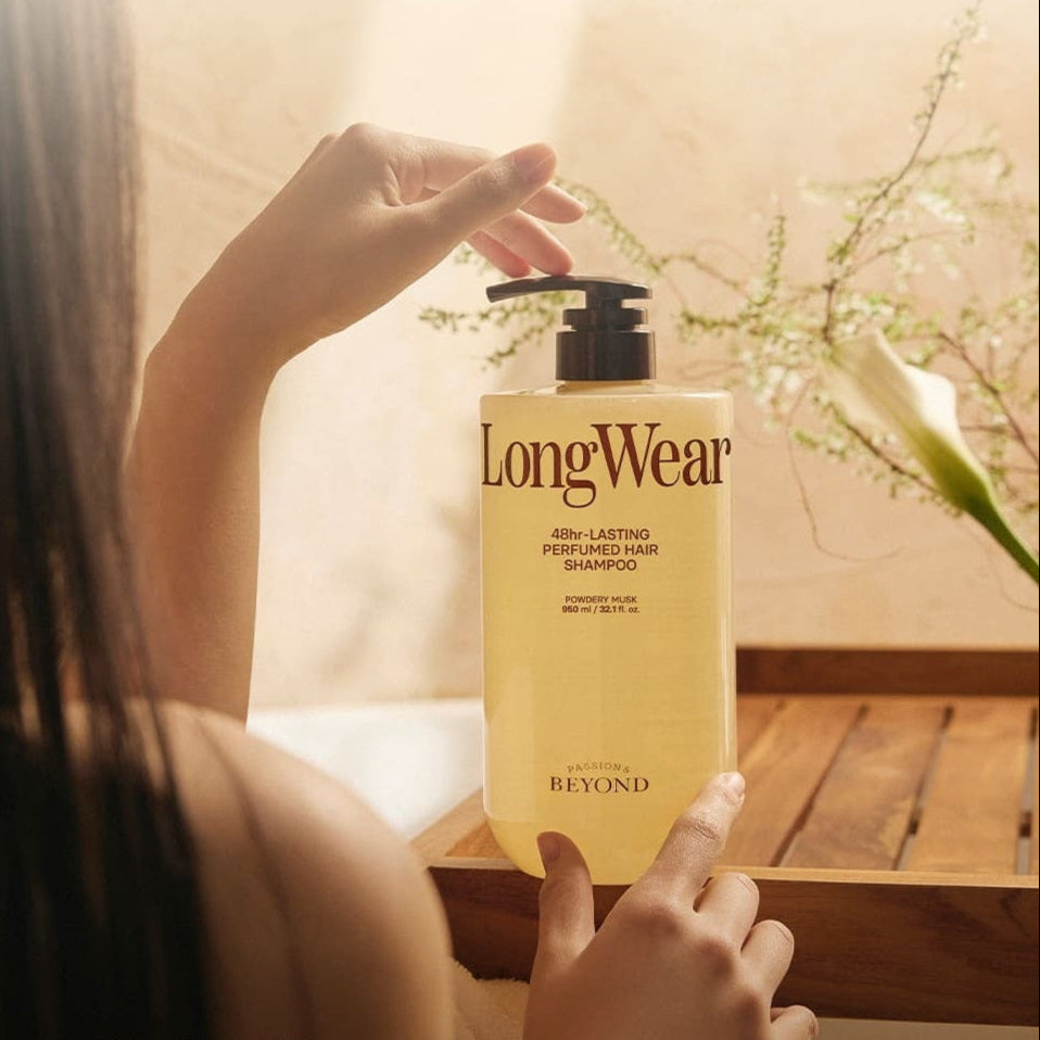 PASSON&BEYOND LongWear 48hr Lasting Perfumed Hair Shampoo 950ml bottle on wooden table with woman holding it in a serene setting