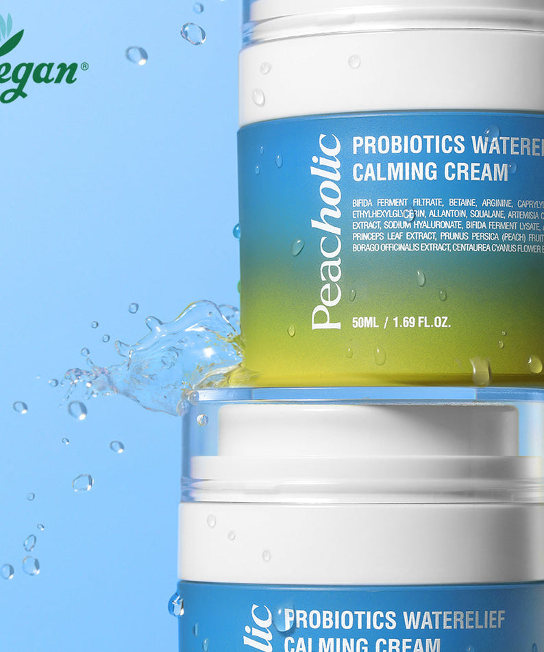 Two jars of PEACHOLIC Probiotics Water Relief Calming Cream 50ml with water splash on a blue background, vegan skincare product.