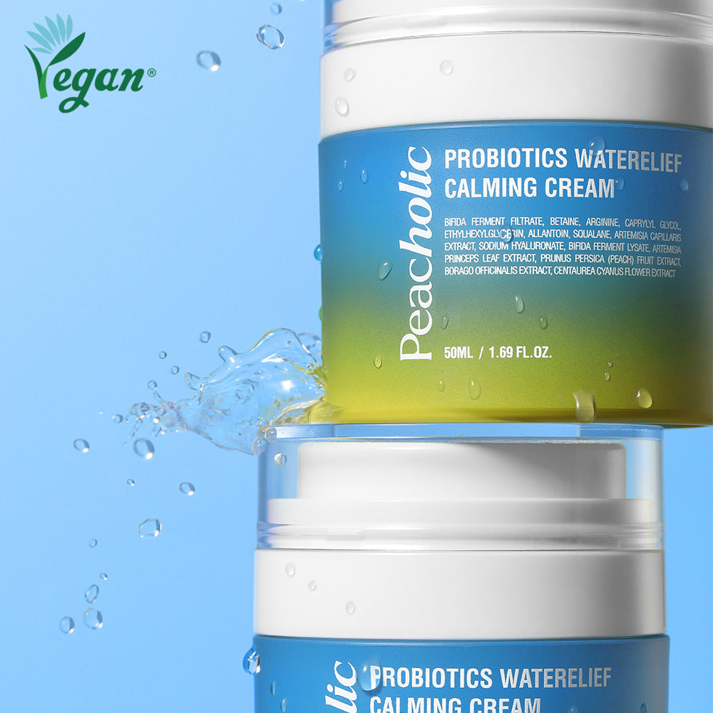 Two jars of PEACHOLIC Probiotics Water Relief Calming Cream 50ml with water splash on a blue background, vegan skincare product.
