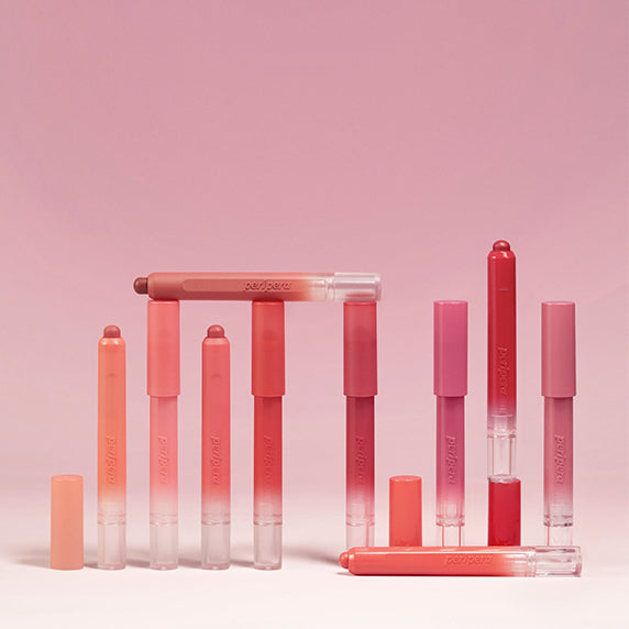 PERIPERA Slip On My Lip lip products in various shades against a pink background.