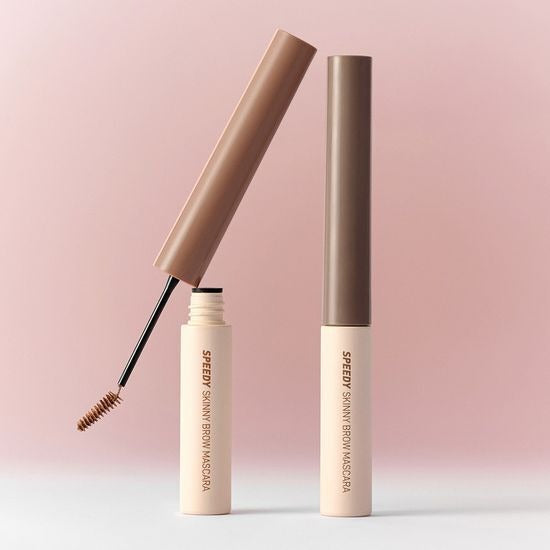 PERIPERA Speedy Skinny Brow Mascara in open brown tube against a pink background, showcasing compact and precise application.