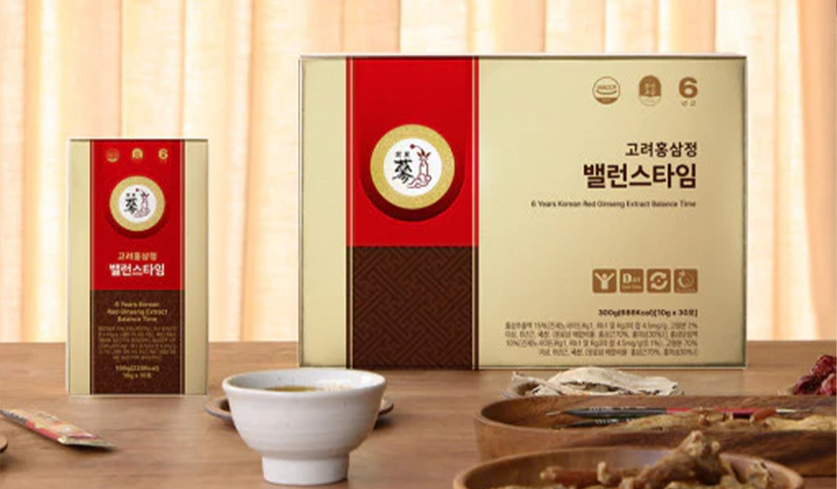Korean red ginseng extract product packaging on a table with a cup and wooden tray.
