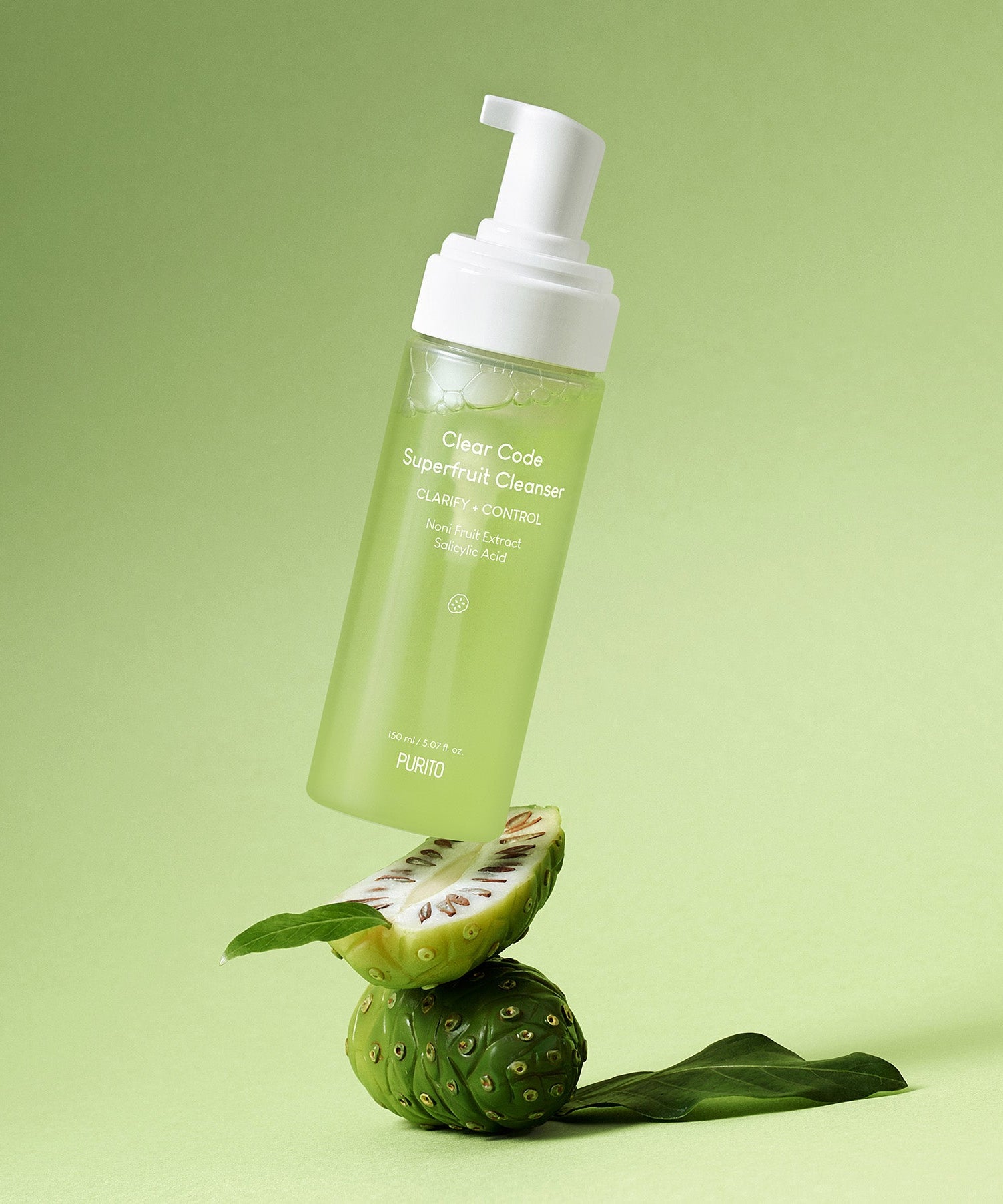 Image of PURITO Clear Code Superfruit Cleanser 150ml bottle on a green background with fruit elements.