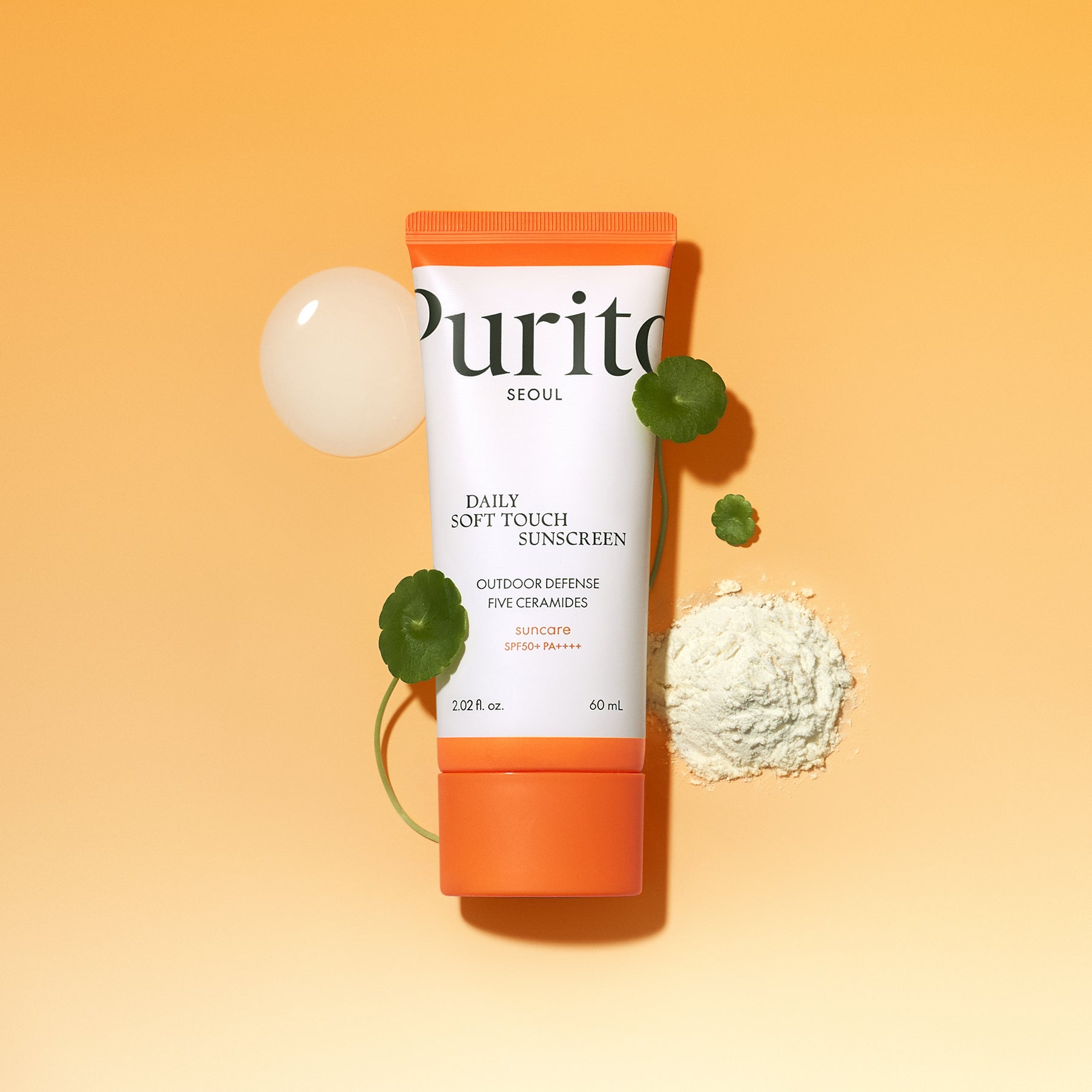 PURITO Daily Soft Touch Sun Cream SPF50+PA++++ with botanical elements on an orange background.