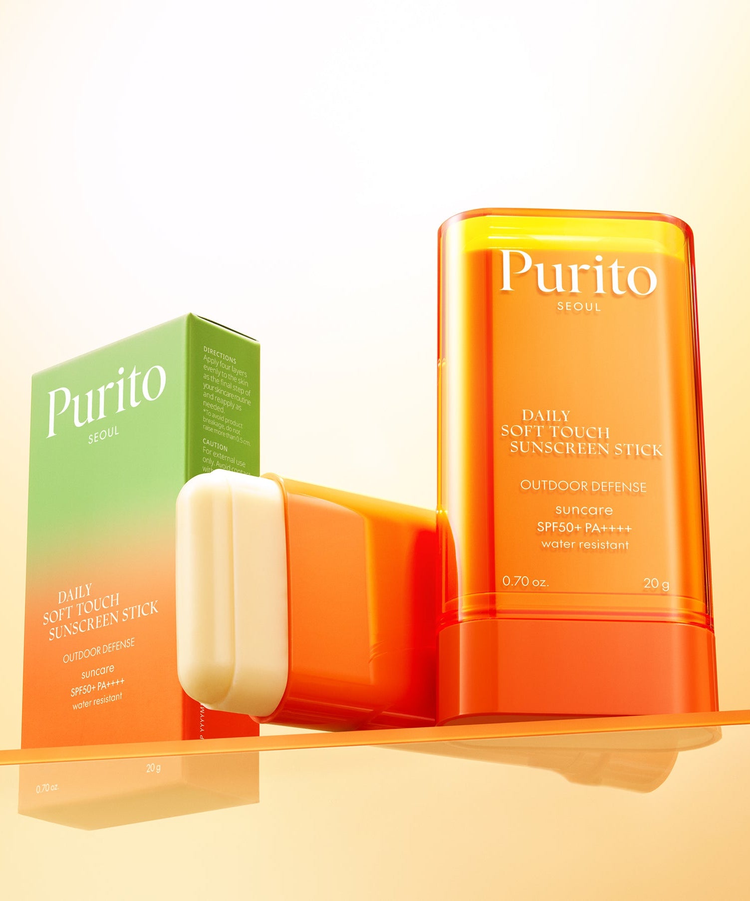 PURITO Daily Soft Touch Sun Stick SPF50+PA++++ displayed with packaging on a reflective surface, highlighting sun protection features.