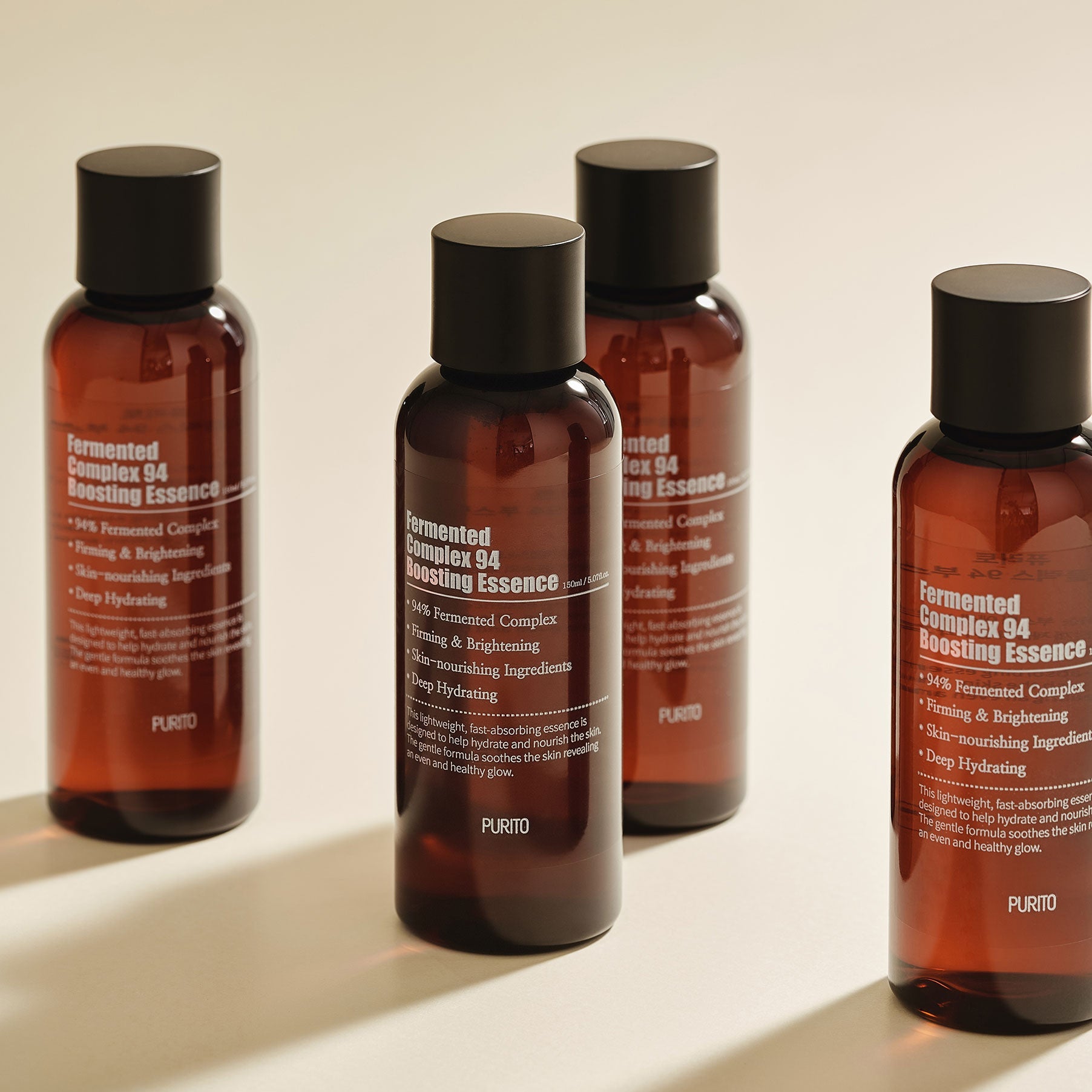 Four bottles of PURITO Fermentedd Complex 94 Boosting Essence 150ml displayed on a neutral background.