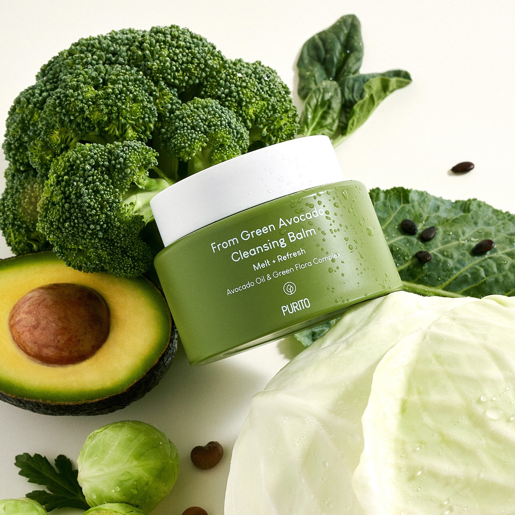 PURITO From Green Avocado Cleansing Balm 100ml surrounded by fresh avocado, broccoli, and cabbage, showcasing natural ingredients.