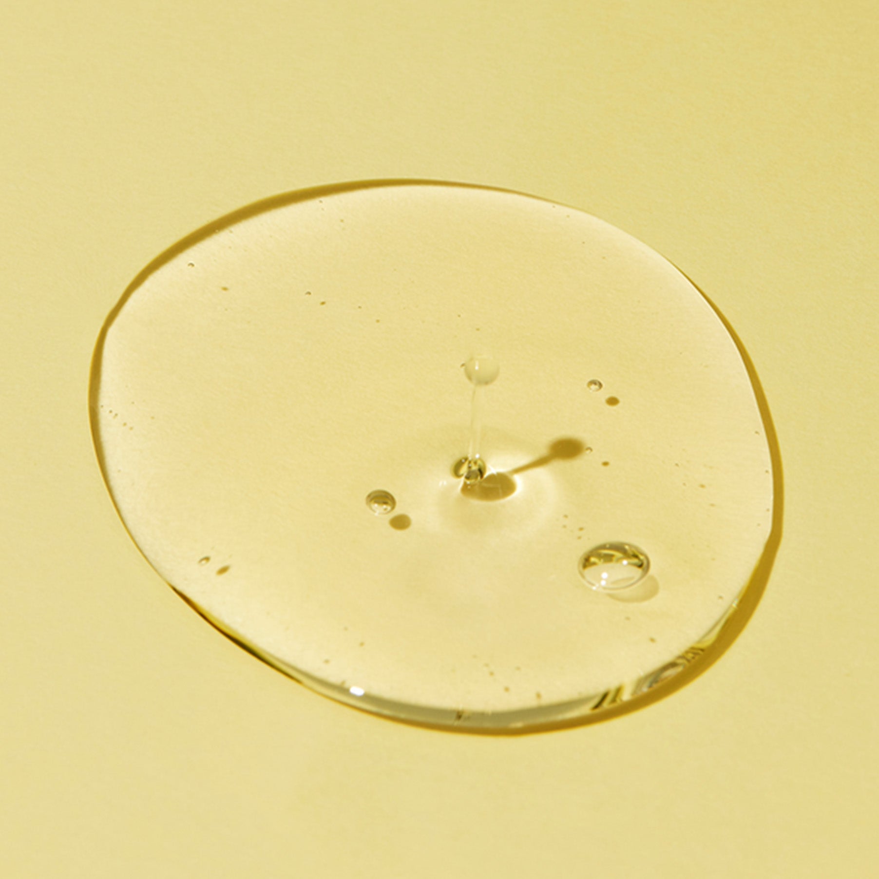 Texture of PURITO From Green Cleansing Oil 200ml on a yellow background