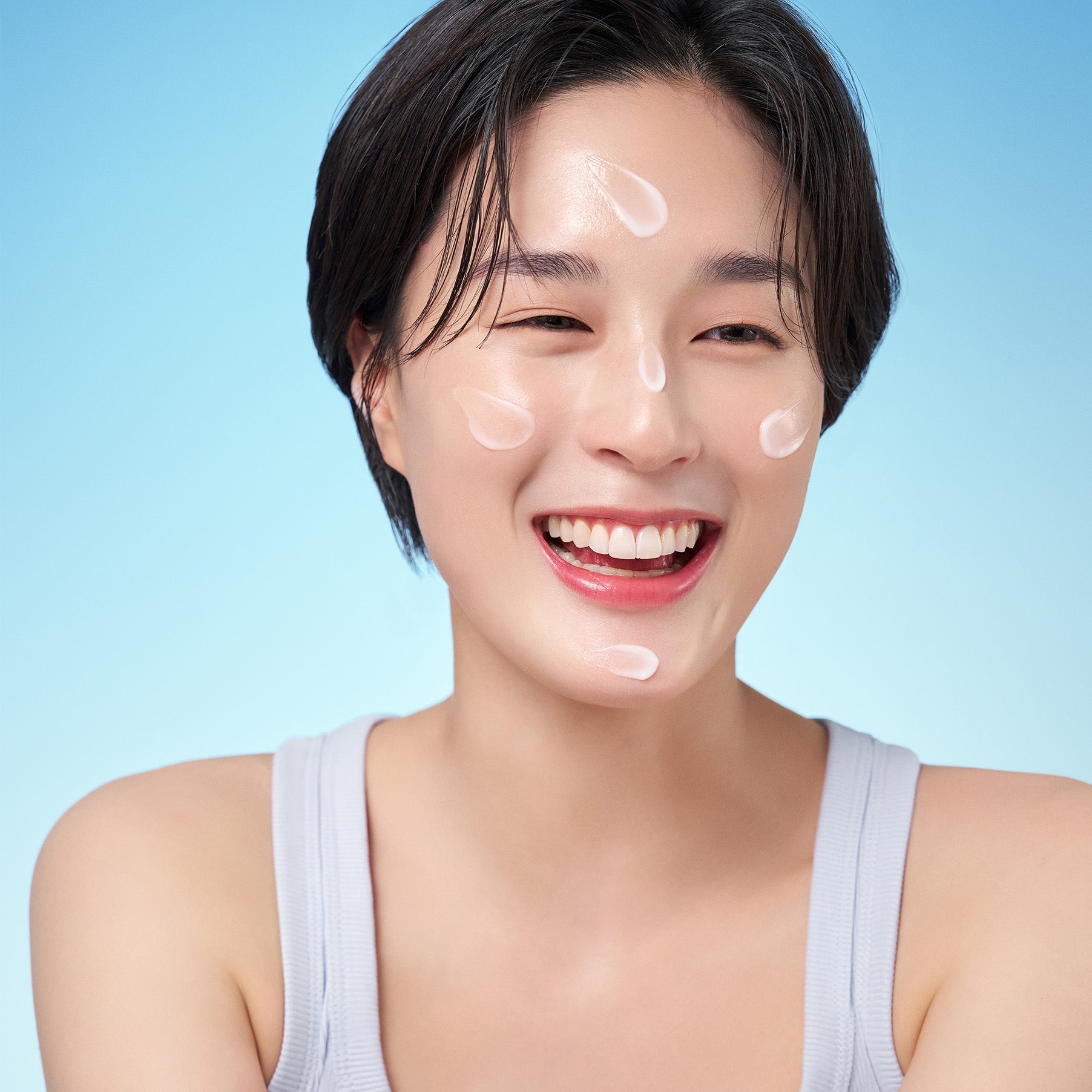 Smiling woman applying PURITO Hydro Wave Deep Sea Cream 50ml on face, showing hydrated skin.