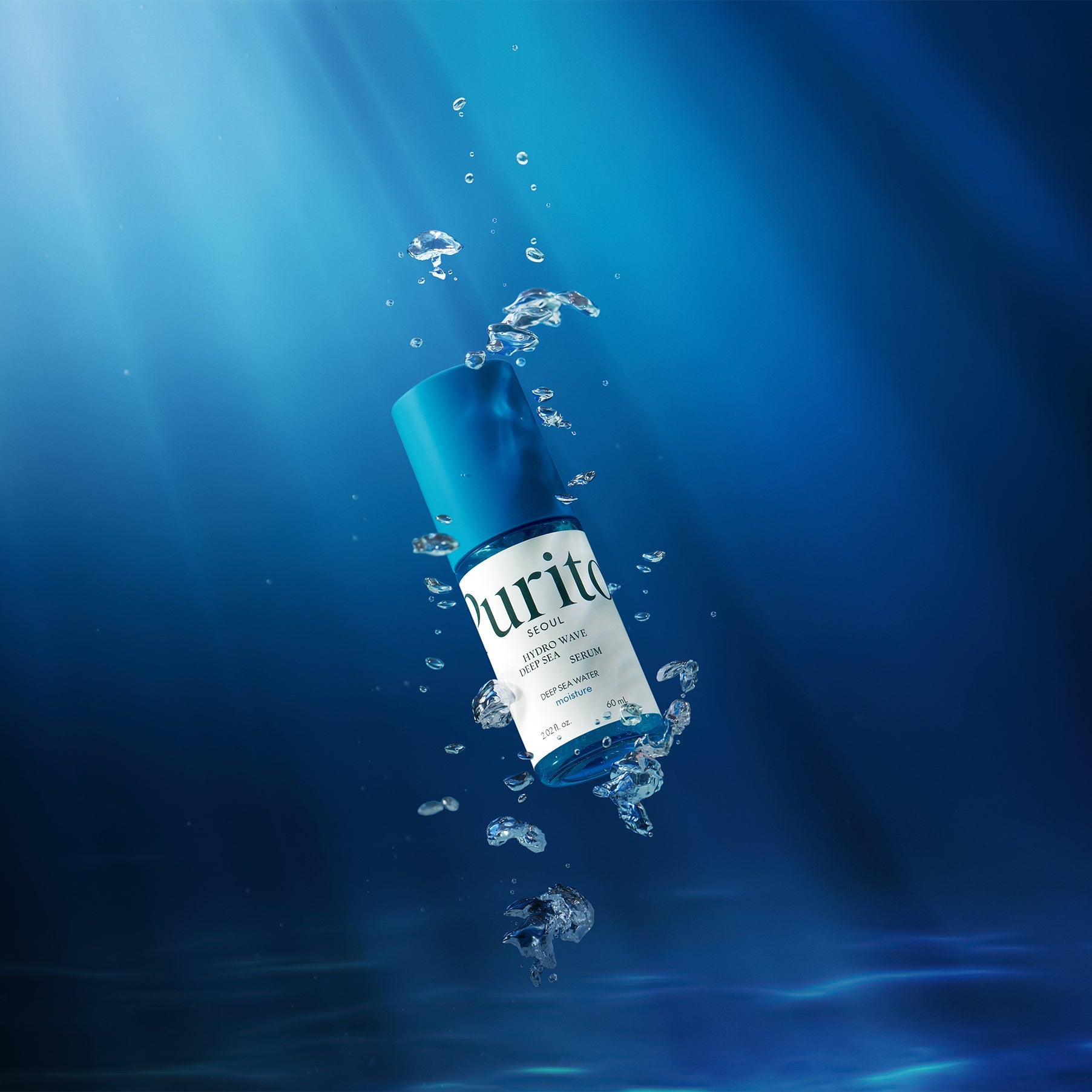 PURITO Hydro Wave Deep Sea Serum 60ml submerged in water with bubbles and deep blue background