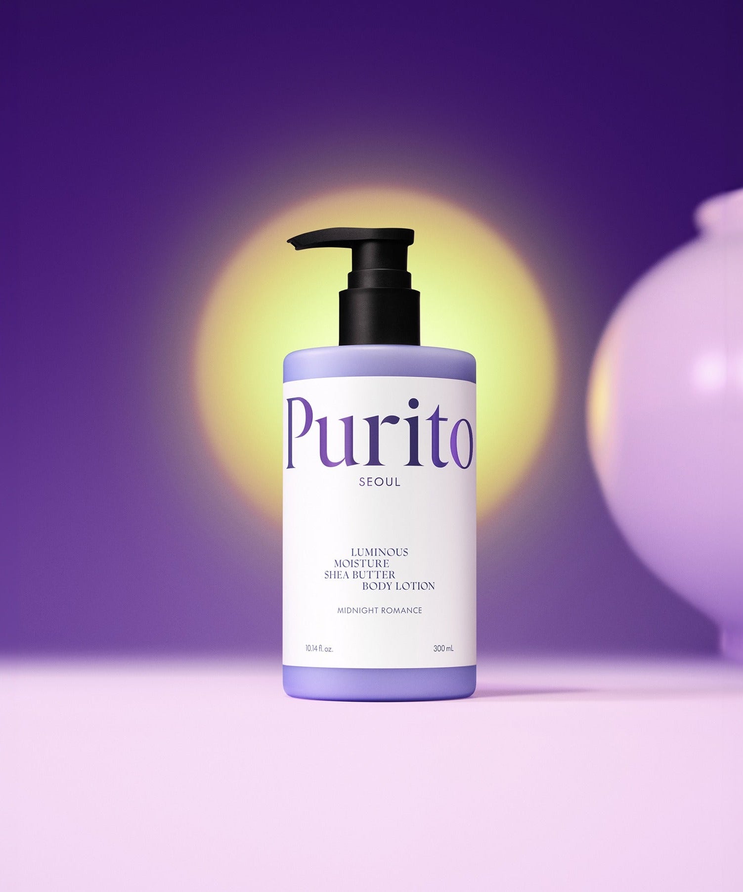 PURITO Luminous Moisture Shea Butter Body Lotion 300ml in purple bottle on purple background with yellow lighting.