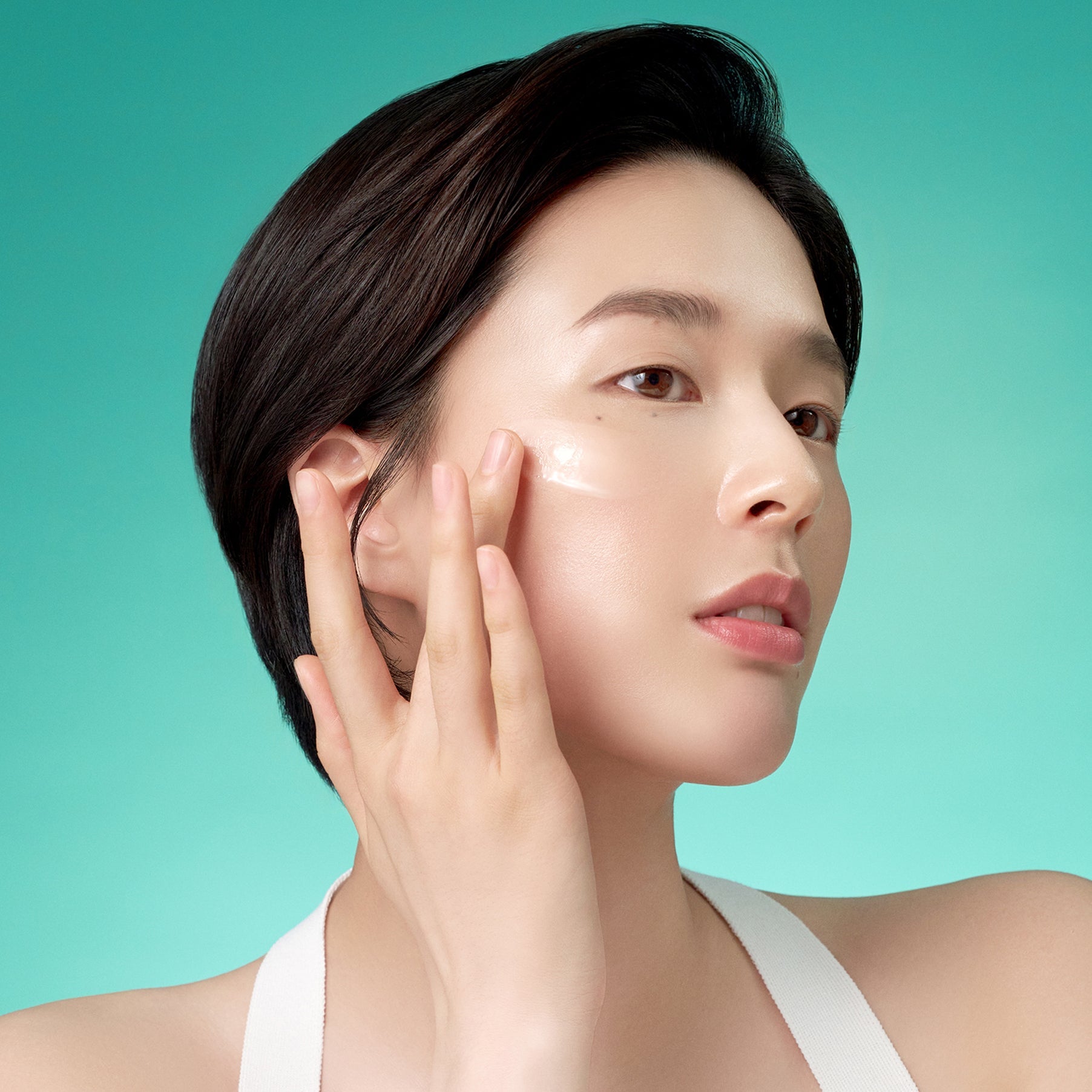 Woman applying PURITO Mighty Bamboo Panthenol Serum 30ml on skin, showcasing product use and benefits.