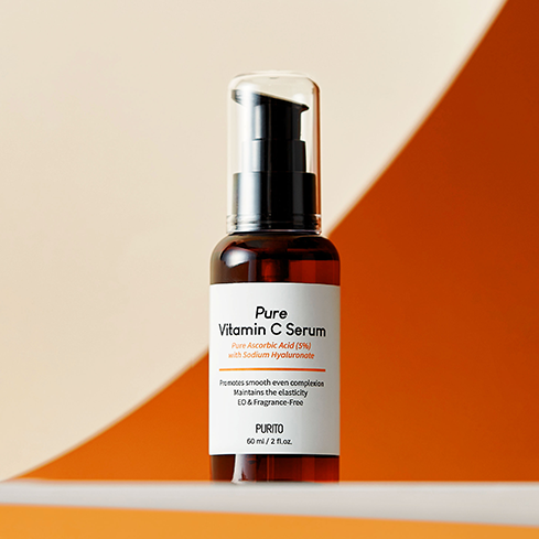 PURITO Pure Vitamin C Serum 60ml on an orange and white background highlighting the bottle's design and label details.