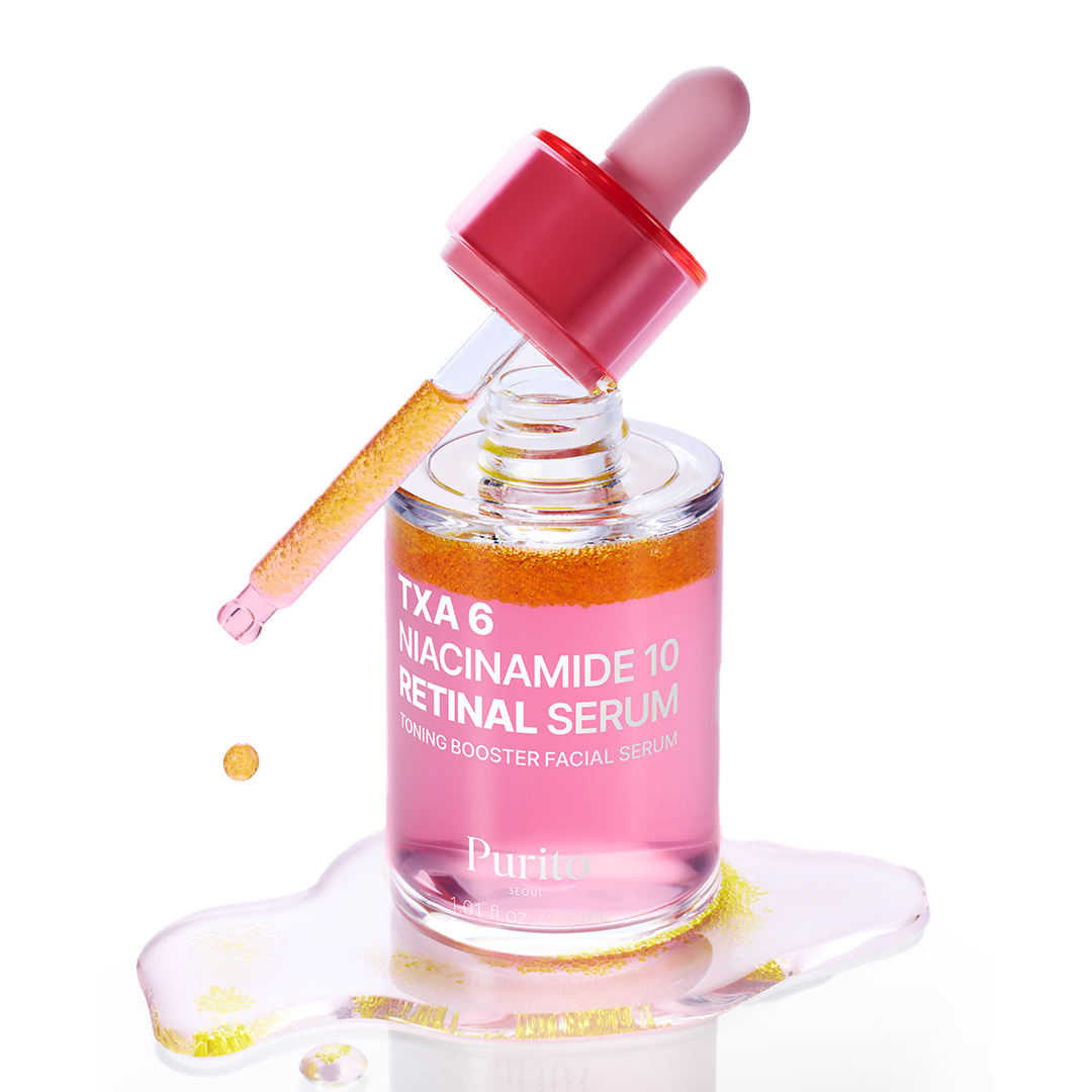 Bottle of PURITO Tranexamic Acid 6 Niacinamide 10 Retinal Serum 30ml with dropper and pink serum spill on white background.